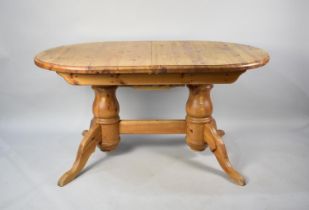 An Extending Oval Pine Dining Table, 189cms by 91cms