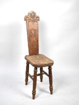 An Early/Mid 20th Century Welsh Oak Spinning Chair with Carved Seat and Back