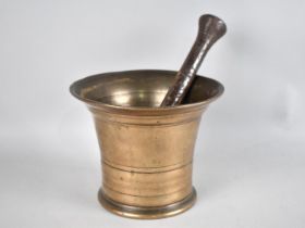 A 19th Century Polished Bronze Mortar together with an Earlier Iron Pestle, 14cms Diameter