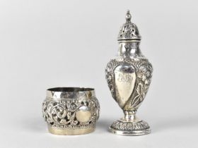 A Silver Shaker of Lobed Form Having Floral Repousse Decoration Together with a White Metal Napkin