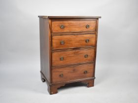 An Edwardian Small Chest of Four Long Drawers with Bracket Feet, 57cms Wide and 80.5cms High