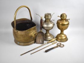 A Mid 20th Century Brass Helmet Shaped Coal Scuttle together with Brass Handled Fire Irons and Two