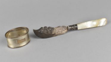 A Victorian Silver Bladed and Mother of Pearl Handled Butter Knife Together with a Silver Napkin