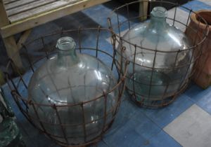 Two Large Glass Demijohns in Wire Surrounds, 51cm high