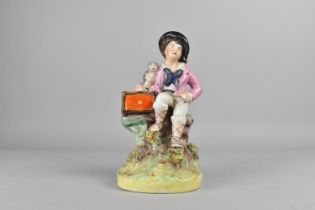 A Staffordshire Type Figure of Seated Boy with Monkey, 17cm high (Condition Issues)