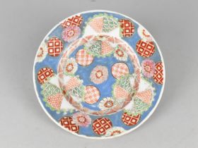 A Japanese Porcelain Plate with Enamel Decoration Incorporating Flowers and Geometric Patterns the