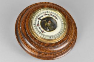 An Edwardian Circular Oak Framed Aneroid Wall Barometer, 19cms Diameter