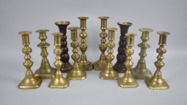 A Collection of Various Brass and Wooden Candlesticks