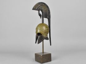 A Contemporary Souvenir Model of an Ancient Greek Helmet Set on Polished Marble Stand in The