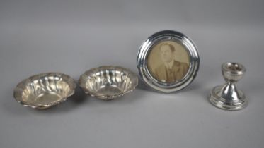 A Small Silver Candlestick, Two Pressed White Metal Dishes Stamped Silver and a Circular Silver