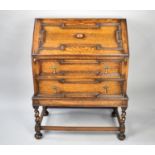 A Mid 20th Century Oak Fall Front Bureau with Two Base Drawers Having Fielded Decoration and Brass