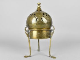 An Eastern Islamic Brass Censer with Pierced Dome Top and Tripod Base, 23cms High