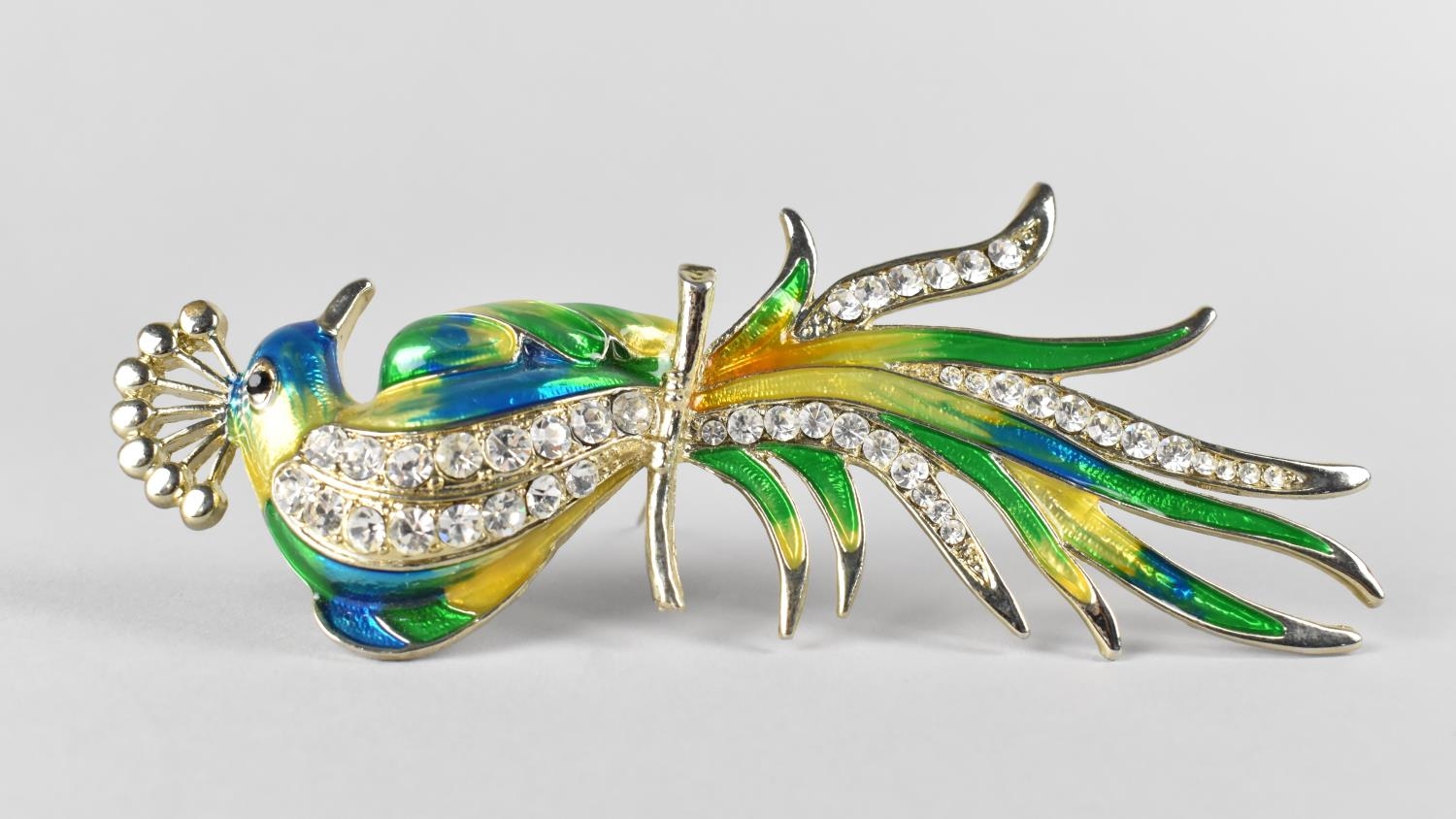 A Large Enamel and Metal Jewelled Brooch in the Form of a Peacock, 14cm high