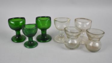 A Collection of Plain and Green Glass Eye Baths