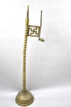 An Indian Brass Temple Lamp Stand with Graduated Bobbin Support, Hindu Good Luck Sign and Dragon's