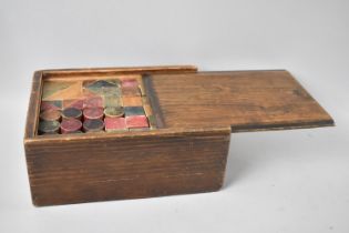 A Mid 20th Century Box Containing 132 Building Blocks Made From One Single Wooden Block, 23cms Long