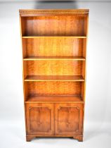 A Modern Yew Wood Library Bookcase with Three Adjustable Shelves and Base Cupboard, Dentil