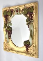 A Large Heavy Moulded Composition Wall Mirror Decorated with Vine Leaves and Grapes, Ribbons Etc,