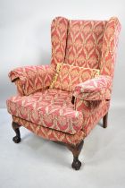 A Modern Upholstered Wing Armchair with Mahogany Claw and Ball Feet