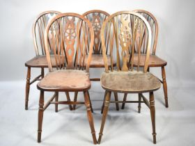 A Harlequin Set of Five Wheel Back Dining Chairs