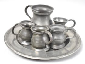 A Pewter Side Plate together with Five Pewter Measures