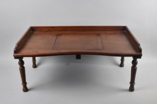 An Edwardian Mahogany Bed Table with Galleried Top and Hinged Centre Bookrest, Turned Supports,