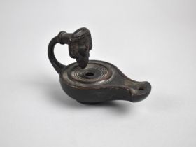 A Patinated Bronze oil Lamp with Mask Decoration to Handle, 12cms Long