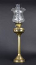 An Edwardian Brass Oil Lamp, Support in the Form of a Ribbed Column with Glass Shade and Chimney,