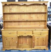 A Modern Pine Kitchen Dresser, the base with Three Drawers Two Cupboard and Open Display, Raised Two