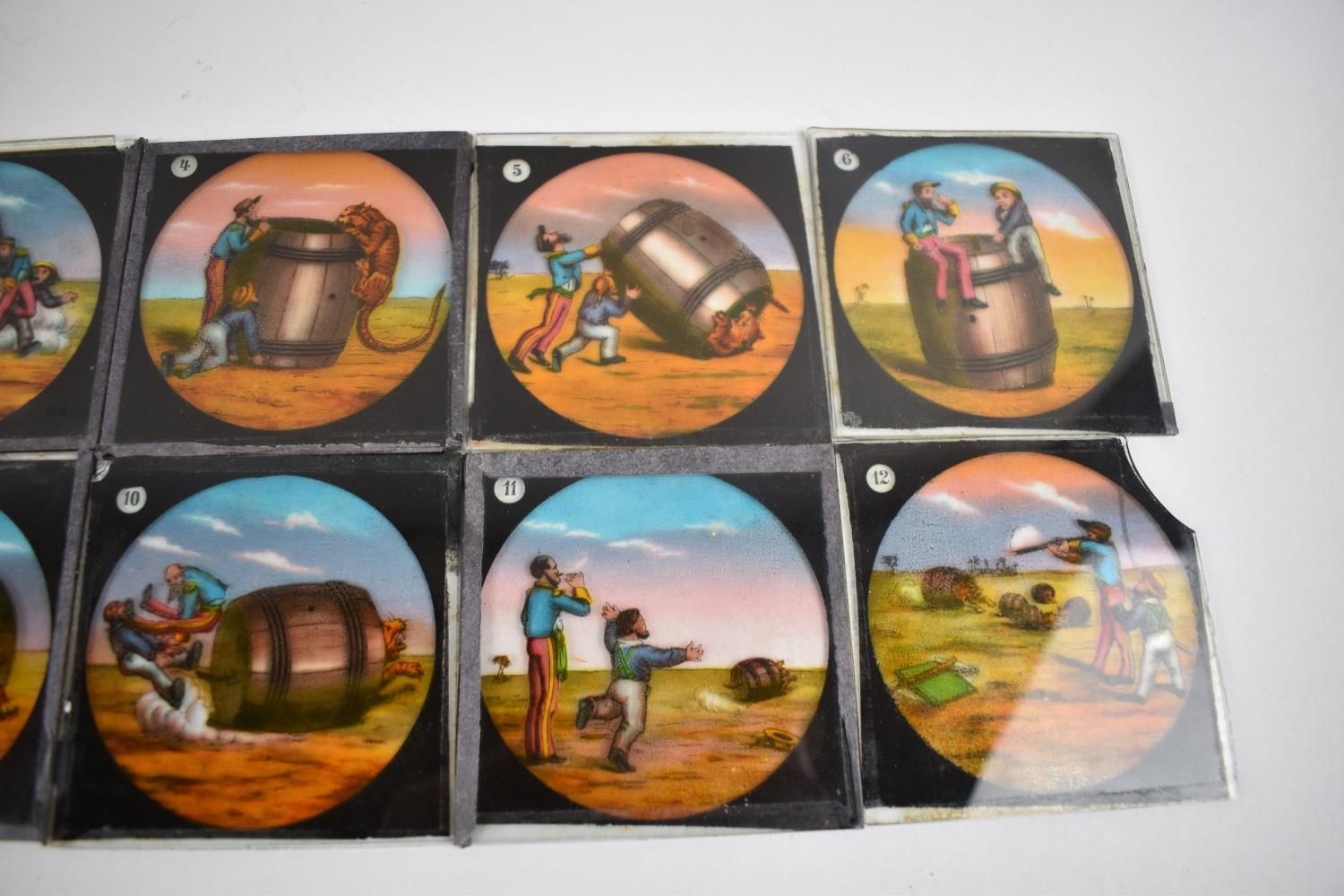 A Collection of 12 Coloured Magic Lantern Slides depicting Two Men Trying to Catch a Tiger in a - Image 3 of 3
