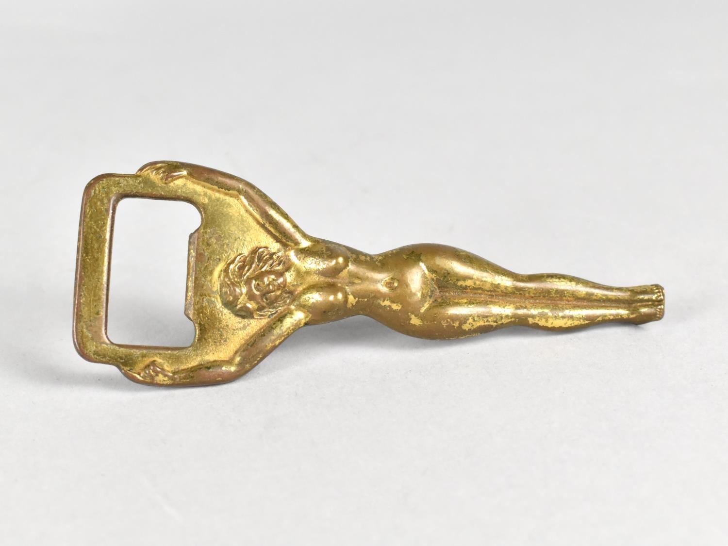 A Mid 20th Century Novelty Brass Bottle Opener, The Handle in the Form of a Nude Maiden, 10.5cms