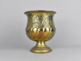 A Brass Vase with Heraldic and Laurel Leaf Decoration in Relief, 19.5cms Diameter and 23cms High