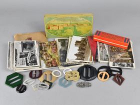 A Collection of Curios to include Postcards, Belt Buckles, Mouth Organ, Vintage Tin