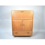 An Ercol Side Cabinet with Pull Down Front, Cupboard Centre, Long Drawer to Base together with Three