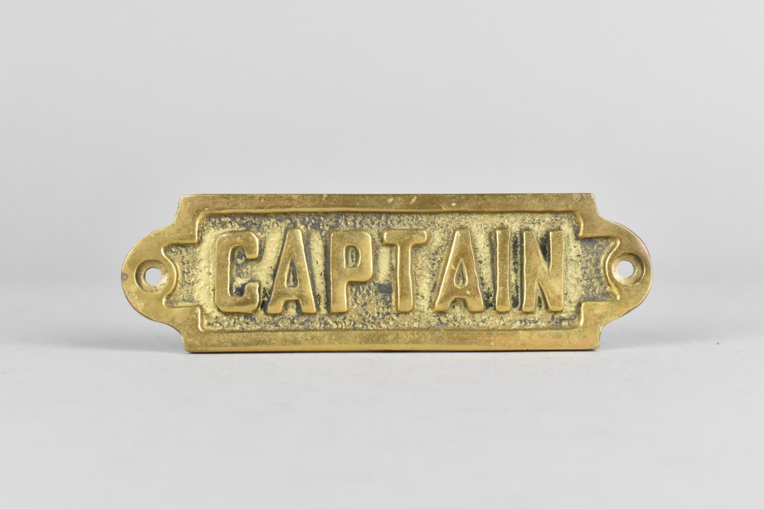 A Small Cast Brass Door Sign, "Captain", 11.5cms Long