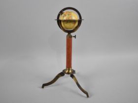 A Reproduction French Style Miniature Tabletop Globe with Leather Mounted Support and Tripod Base,