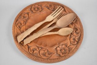 A Mid 20th Century Carved Circular Wooden Bread Plate together with Wooden Spoons and Forks