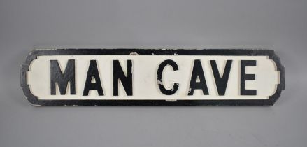 A Modern Painted Wooden "Man Cave" Sign, 64cms Wide