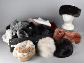 A Large Collection of Various Faux Fur Hats and Ear Warmers