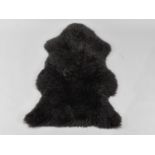 A Black Sheepskin Rug, Approx 97x60cm