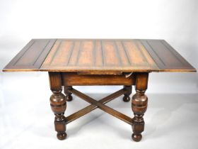 An Edwardian Oak Drawer Leaf Dining Table with Bulbous Supports