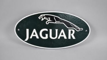 A Reproduction Cast Metal Cold Painted Oval Sign for Jaguar, 35cms Long