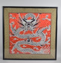 A Framed Embroidered Silk Panel Depicting Dragon and Flaming Pearl, 48cms Square