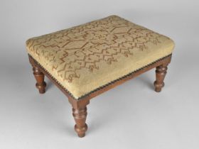 A Tapestry Upholstered Rectangular Footstool with Turned Mahogany Supports, 40cms Long