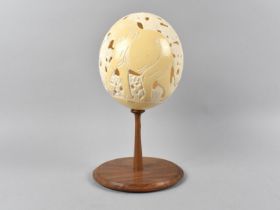 A Carved and Pierced Souvenir Ostrich Egg Decorated with Elephant and Trees, Condition Issues, 24.