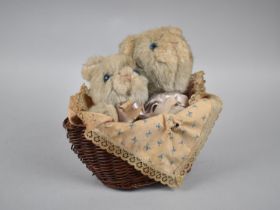 A Mid 20th Century Musical Toy in the Form of a Basket Containing Kittens with Plastic Eyes