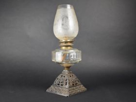 A Victorian Oil Lamp with Pierced Cast Iron Base, Glass Reservoir and Etched Glass Shade, 46cms High