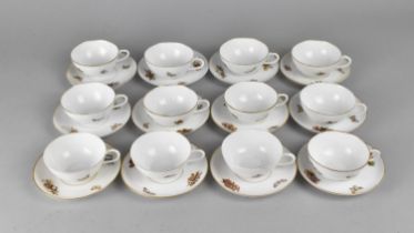 A Continental Porcelain Set of Twelve Cups and Saucers Decorated with Cherubs, Butterflies etc (Some