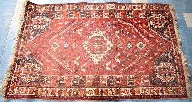 A Vintage Patterned Woollen Rug on Red Ground, 257x160cm