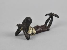 A Small Cold Painted Bronze Figure of Reclined African Gent Smoking Pipe